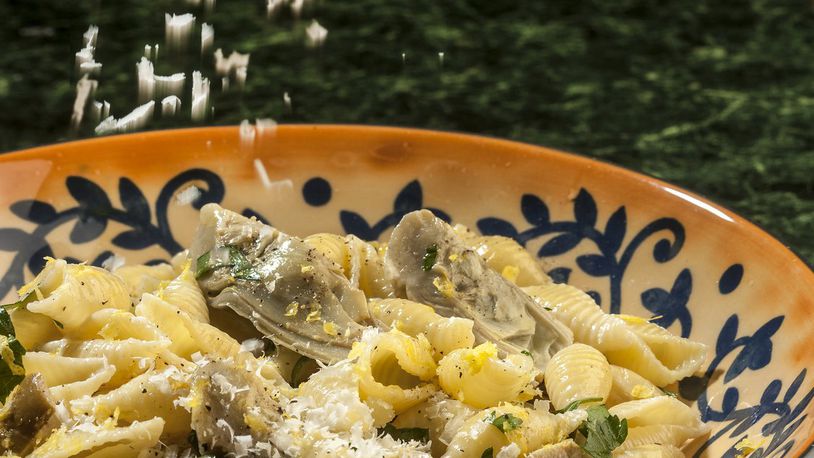 Baby artichokes get a generous dusting of grated Romano cheese in this pasta dish, enriched with cream and enlivened by fresh lemon. (Bill Hogan/Chicago Tribune/TNS)