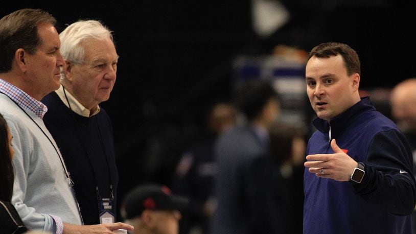 Dayton’s Archie Miller, right, talks to Jim Nantz and Bill Raftery, of CBS, during a NCAA tournament practice on Thursday, March 16, 2017, at Bankers Life Fieldhouse in Indianapolis. David Jablonski/Staff
