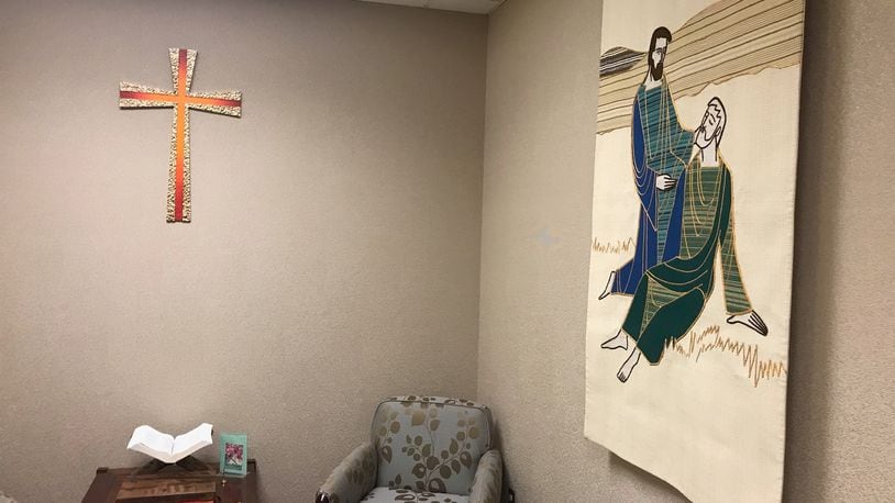 The cross and Good Samaritan tapestry were moved from the former hospital and are now displayed in the meditation room at the Miami Valley Hospital North Campus in Englewood. KAITLIN SCHROEDER