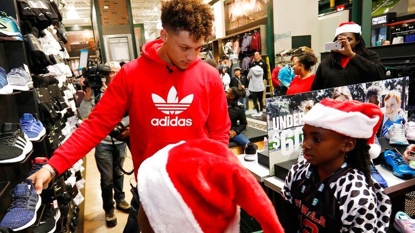 Kansas City Chiefs quarterback Patrick Mahomes II serves as a personal shopping assistant for players from local KC United youth football organization at the DICK'S Sporting Goods, Tuesday, Nov. 27, 2018 in Leawood, Kan.