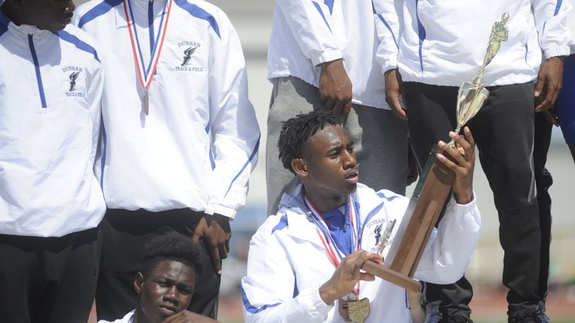 Dunbar’s Jalani Allen admires the boys state championship trophy during the D-II state track and field meet at OSU’s Jesse Owens Memorial Stadium in Columbus on Saturday, June 3, 2017. MARC PENDLETON / STAFF