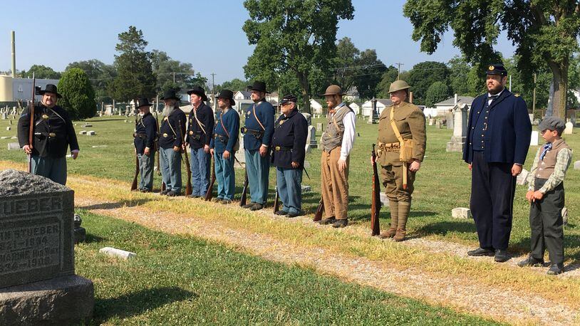 A group of Middletown area Civil War re-enactors of the 12 Ohio Volunteer Infantry render honors at a memorial service of a veteran at the Middletown Pioneer Cemetery. ED RICHTER/STAFF