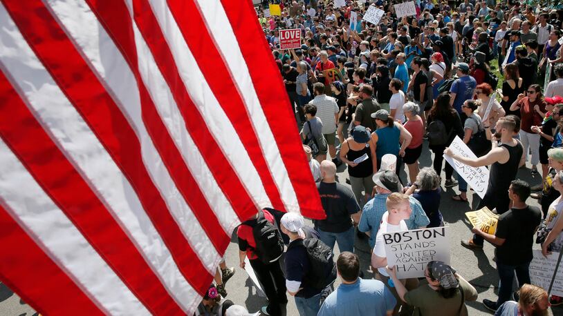 Counterprotesters assemble at the Statehouse before a planned "Free Speech" rally by conservative organizers begins on the adjacent Boston Common, Saturday, Aug. 19, 2017, in Boston. (AP Photo/Michael Dwyer)