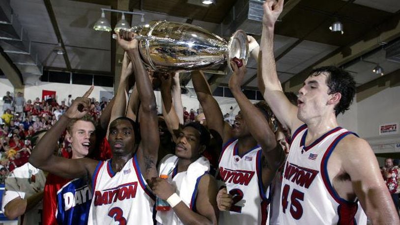 Dayton players, from left to right, Greg Kohls, Ramad Marshall, Warren Williams, Frank Iguodala and Keith Waleskowski celebrates with the championship trophy after defeating Hawaii 82-72 in the championship game at the Maui Invitational in Lahaina, Hawaii Wednesday, Nov. 26, 2003.   (AP Photo/Michael Conroy)