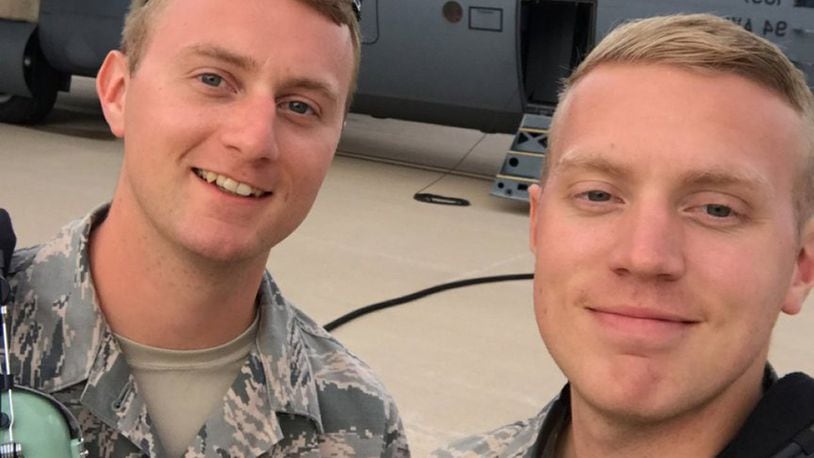 Tech. Sgt. Joel Putnam (left), a 94th Aircraft Maintenance Squadron crew chief, and his brother, Staff Sgt. Jeremy Putnam, a 94th Maintenance Squadron aerospace propulsion technician, pose for a photo in front of a C-130H3 Hercules at Dobbins Air Reserve Base, Ga. (U.S. Air Force photo/Senior Airman Justin Clayvon)