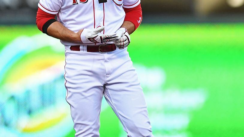CINCINNATI, OH - AUGUST 9:  Joey Votto #19 of the Cincinnati Reds removes his pad and gloves after hitting a double in the first inning against the San Diego Padres at Great American Ball Park on August 9, 2017 in Cincinnati, Ohio.  (Photo by Jamie Sabau/Getty Images)
