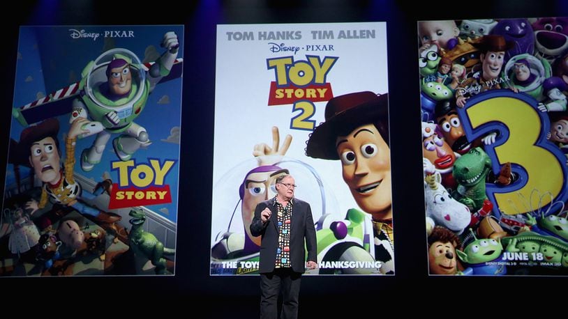 Director John Lasseter presents at "Pixar and Walt Disney Animation Studios: The Upcoming Films" presentation at Disney's D23 EXPO 2015 in Anaheim, Calif.  Bud Luckey, credited with creating Sheriff Woody (pictured on images behind Lasseter) from the "Toy Story" franchise, has died. (Photo by Jesse Grant/Getty Images for Disney)