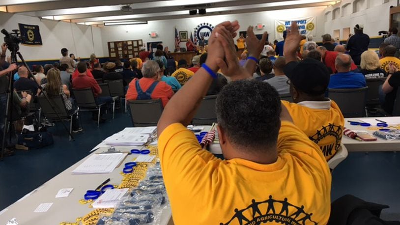 United Auto Workers organizers and workers respond to a speaker at a meeting Sunday at UAW Local 696’s hall in Dayton. The UAW is trying to gather enough election authorization signatures to force a representation election at Fuyao Glass America in Moraine. THOMAS GNAU/STAFF