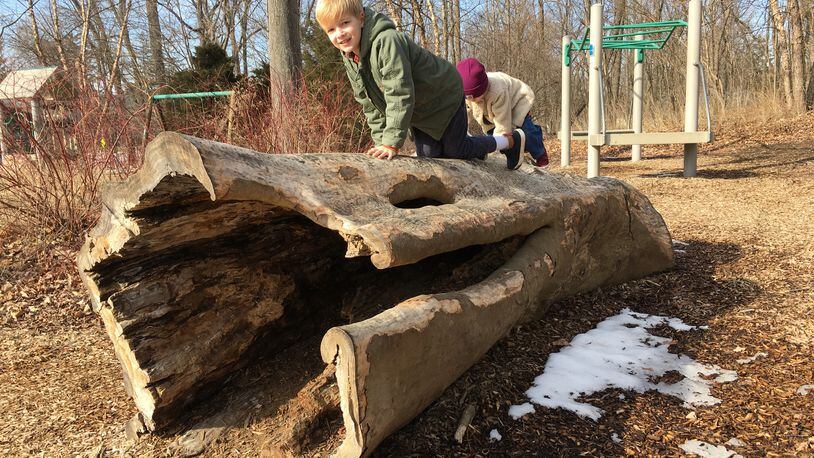 Axel Ohl and his sister, Charlotte Ohl, of Kettering, play at the nature play area at Hills & Dales MetroPark . PHOTO CREDIT: Sarah Franks