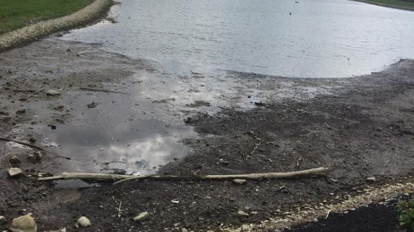 The level of Remick Lake is being lowered by two feet while litigation over who should pay for necessary improvements continues.