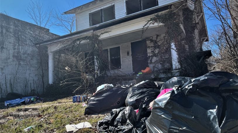 A vacant home with trash in the yard in West Dayton. CORNELIUS FROLIK / STAFF