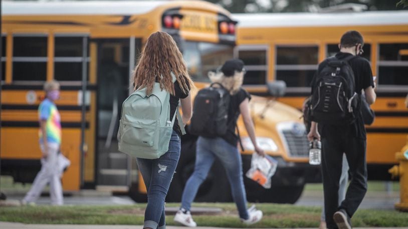 Mad River Middle School students load onto the buses after the first day of school Sept. 8, 2020. Jim Noelker/Staff