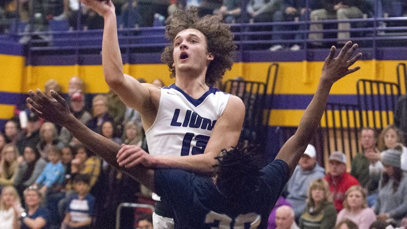 Emmanuel Christian’s Casey Swank shoots over Legacy Christian’s Keano Hammerstrom during Friday night’s game at Emmanuel in Springfield. Swank scored 14 points to help lead ECA to a 75-60 victory. Jeff Gilbert/CONTRIBUTED
