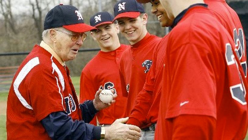 Former North baseball coach Don Henderson shakes hands with the current players after throwing out a ceremonial first pitch to his former player, North assistant Doug Stoll, before North played Northwestern in the Panther Classic Saturday, April 12, 2008. Staff Photo by Barbara J. Perenic
