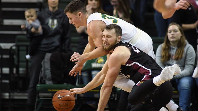 Wright State’s Cole Gentry battles IUPUI’s Evan Hall for a loose ball during the Raiders’ win against the Jaguars earlier this season. KEITH COLE/CONTRIBUTED PHOTO