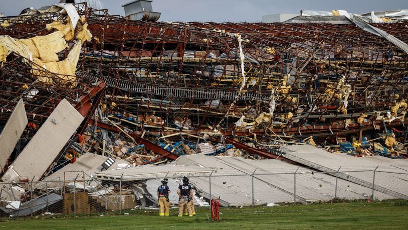 Firefighters are shown near the damage at the Meijer Distribution Center in Tipp City near Interstate 75 after a tornado struck the area on Wednesday, June 8, 2022. JIM NOELKER/STAFF
