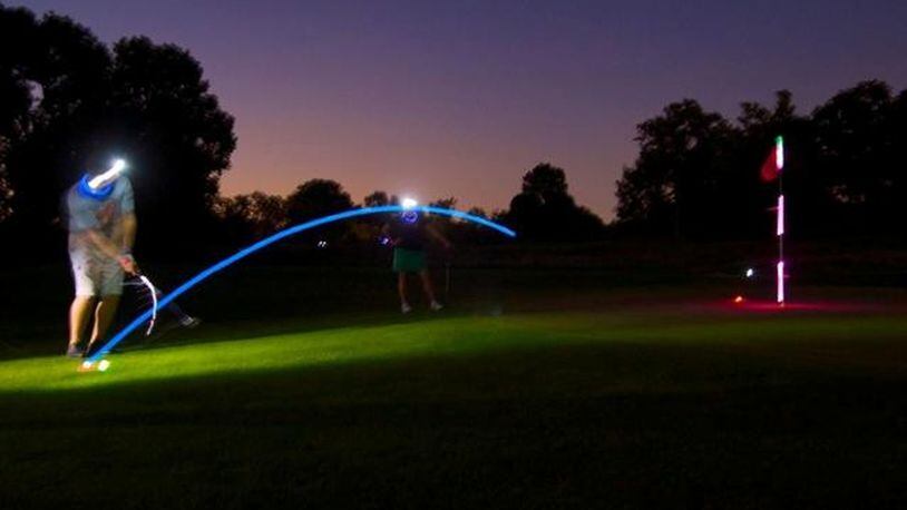 Golfers putting in the dark during a previous A Special Wish Foundation — Dayton Chapter’s Glow Fore Wishes fundraiser. CONTRIBUTED