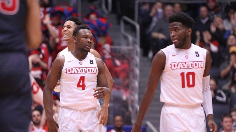 Dayton's Jordan Davis, front left, and Darrell Davis, back left, celebrate after a 3-pointer by Jordan as Jalen Crutcher, right, watches during a game against Duquesne on Wednesday, Feb. 7, 2018, at UD Arena.
