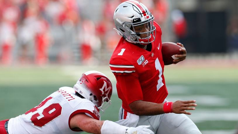 Ohio State quarterback Justin Fields, right, cuts upfield on his way to a touchdown against Miami (Ohio) defensive back Bart Baratti during the first half of an NCAA college football game Saturday, Sept. 21, 2019, in Columbus, Ohio. (AP Photo/Jay LaPrete)