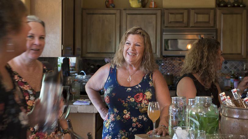 Marcie Dubreville chats with other Garden Goddesses while tasting founding goddess Susan Gouveia’s homemade mead at an informal goddess gathering at Gouveia’s Grass Valley, Calif. home on July 6, 2017. (Emily Zentner/Sacramento Bee/TNS)