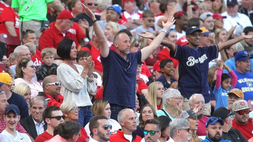 Former Reds closer Jeff Shaw, center, and his wife Julie celebrate a home run hit by their son, the Brewers’ Travis Shaw, against the Reds on Tuesday, June 27, 2017, at Great American Ball Park in Cincinnati. David Jablonski/Staff