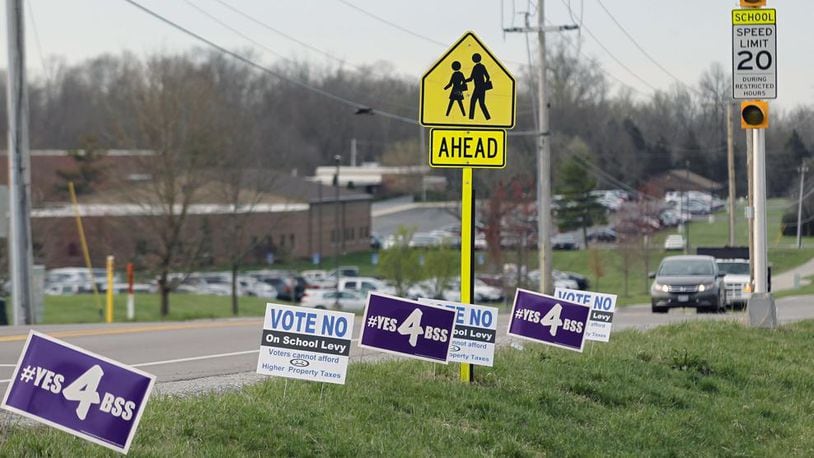 Political signs dotted the sides of roadways in the Bellbrook-Sugarcreek school district in May 2019. TY GREENLEES/STAFF