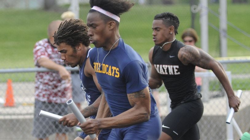 Springfield’s Quincy Scott (closest) overtakes Fairmont’s Marquis Williams (left) and Diante Lesperence of Wayne during a record-setting 4x100 relay. The GWOC track and field championships were at Troy’s Memorial Stadium on Friday, May 11, 2018. MARC PENDLETON / STAFF