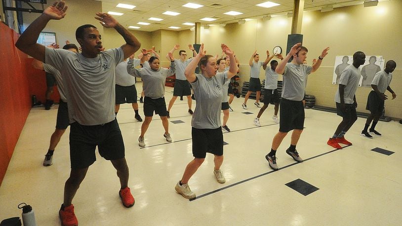 The class of 19 cadets at Sinclair Police Academy performs jumping jacks as part of morning physical training, Thursday, Jan. 11, 2024. MARSHALL GORBY\STAFF