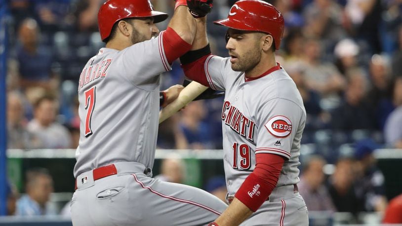 TORONTO, ON - MAY 30: Joey Votto #19 of the Cincinnati Reds is congratulated by Eugenio Suarez #7 after hitting a solo home run in the first inning during MLB game action against the Toronto Blue Jays at Rogers Centre on May 30, 2017 in Toronto, Canada. (Photo by Tom Szczerbowski/Getty Images)