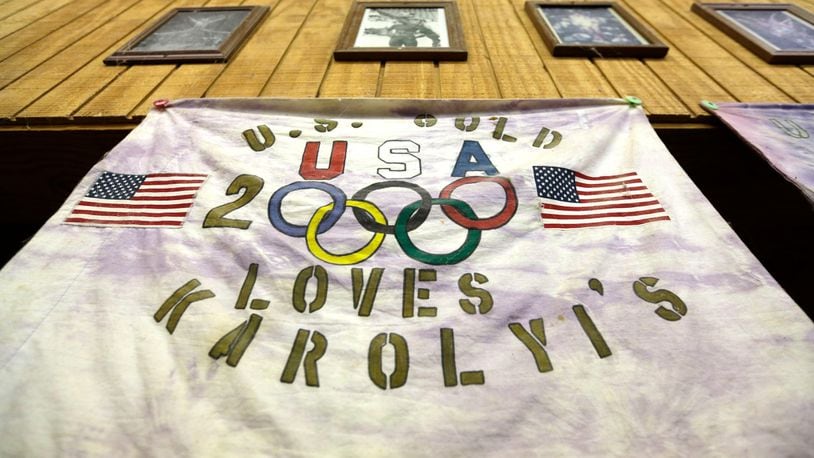 In this Sept, 12, 2015 photo, a banner hangs on the wall inside a gymnastics training gym near New Waverly, Texas. Texas Gov. Greg Abbott on Tuesday, Jan. 30, 2018, has ordered a criminal investigation into claims that former doctor Larry Nassar abused some of his victims at the Texas ranch that was the training ground for U.S. women's gymnastics .(AP Photo/David J. Phillip, File)