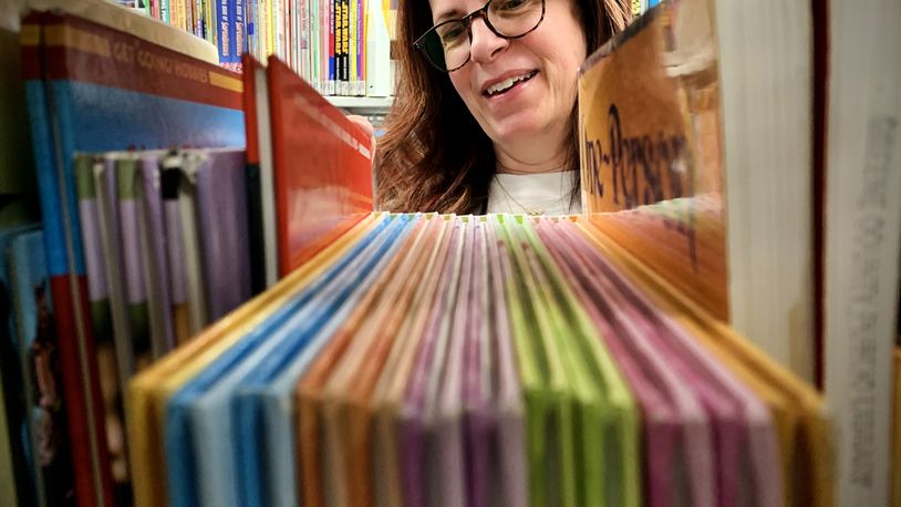 Merrell Dilsavor, a Library Aide at the Fairborn Community Library replaces books Thursday April 28, 2022. MARSHALL GORBY\STAFF