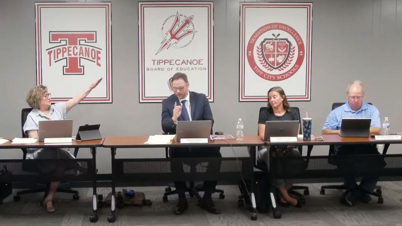 Tipp City school board member Anne Zakkour (left) gave a Nazi salute toward then-board president Simon Patry (second from left) at the Sept. 5 meeting, claiming later that Patry behaved like a dictator. Patry resigned after that meeting.