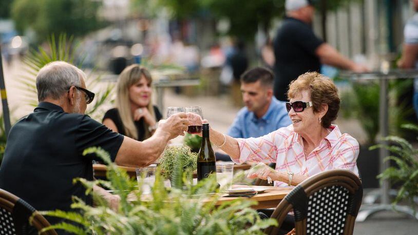 Couples enjoy outdoor dining during First Friday in downtown Dayton. CONTRIBUTED