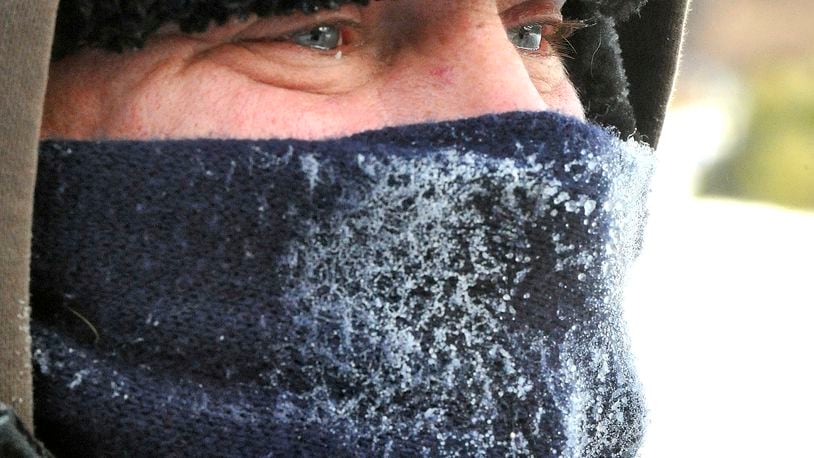 The scarf covering Craig Falke's face is covered with ice as the moisture in his breath freezes while he works outside. Bill Lackey/Staff
