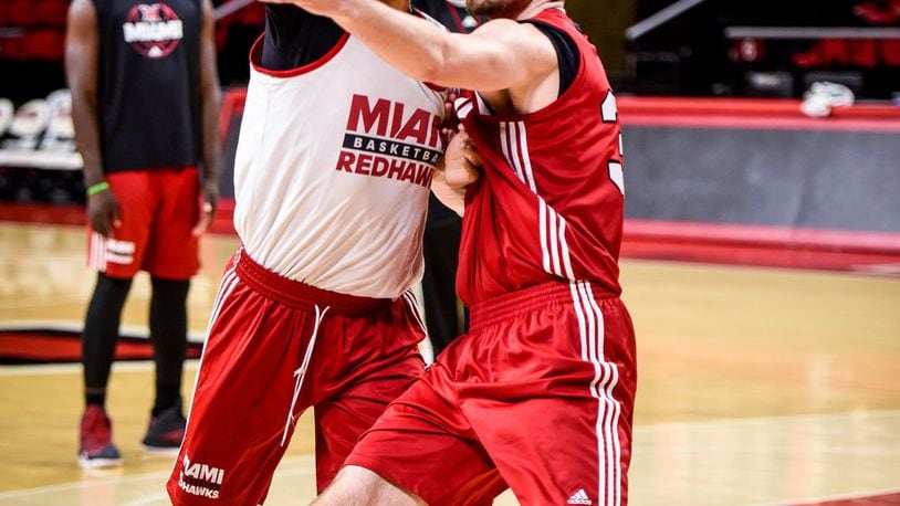 Miami University players Rod Mills Jr., left, and Bruno Solomun from Croatia battle for position during practice Thursday, Jan. 12 at Millet Hall at Miami University in Oxford. The Miami University Redhawks men’s basketball team has six players and a team manager from outside the United States. Miami is among the NCAA basketball teams with the most foreign players on their roster this season. NICK GRAHAM/STAFF