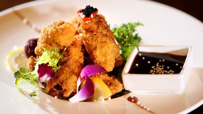 Fried oysters at Ozu 852 are topped with black caviar and served with tonkatsu sauce.Ozu 852 has won the Best Asian Food category in the Best of Dayton contest for numerous years. The restaurant, located at 852 Union Blvd. in Englewood, is known for fresh, quality sushi, hibachi, Chinese and Japanese foods.  LISA POWELL / STAFF