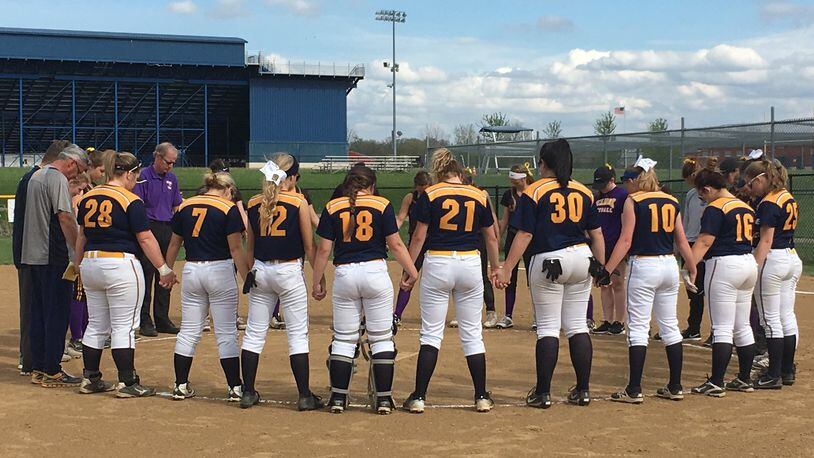 Monroe and Bellbrook players and coaches come together for a pregame prayer at Monroe on Thursday afternoon to honor Monroe senior Kaylie Jackson, who died this week from injuries suffered in a car crash. RICK CASSANO/STAFF