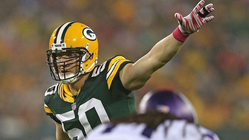 GREEN BAY, WI - OCTOBER 02: A.J. Hawk #50 of the Green Bay Packers calls defensive signals against the Minnesota Vikings at Lambeau Field on October 2, 2014 in Green Bay, Wisconsin. The Packers defeated the Vikings 42-10. (Photo by Jonathan Daniel/Getty Images)