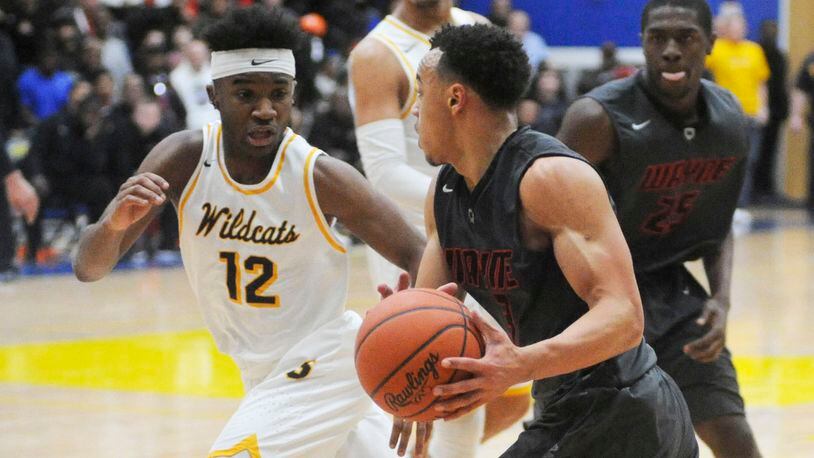 Larry Stephens of Springfield (left) and Darius Quisenberry of Wayne. The GWOC National East teams split in the regular season and both have advanced to D-I district finals. MARC PENDLETON / STAFF