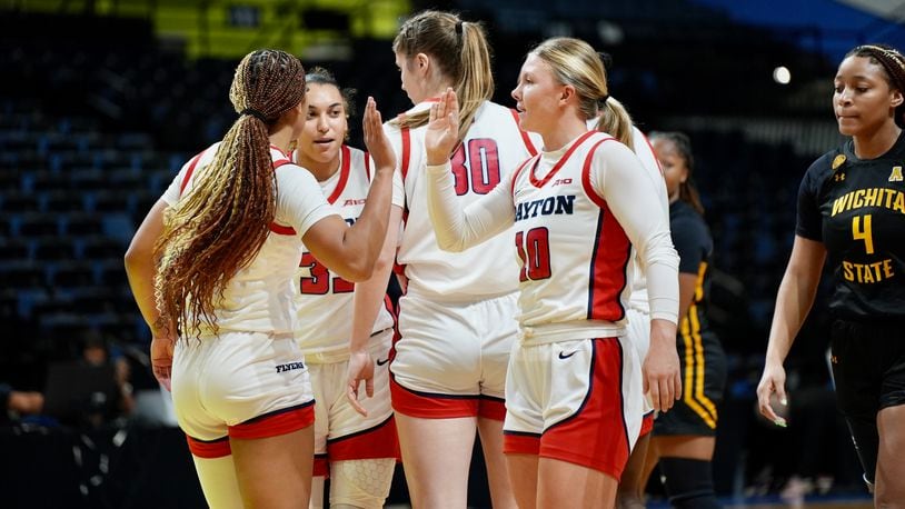 The Dayton women's basketball team, including Ivy Wolf, right, huddles during a game against Wichita State on Saturday, Nov. 25, 2023, in Daytona Beach, Fla. Photo courtesy of UD