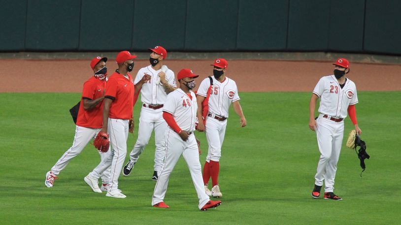 Reds relievers, including Cody Reed, far left, walk back to the dugout after a game on July 24, 2020, at Great American Ball Park in Cincinnati. David Jablonski/Staff