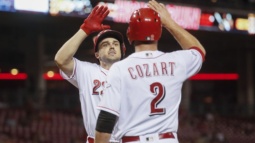 Cincinnati Reds' Adam Duvall, left, celebrates with Zack Cozart (2) after hitting a two-run home run off New York Mets pitcher Rafael Montero in the third inning of a baseball game, Tuesday, Sept. 6, 2016, in Cincinnati. (AP Photo/John Minchillo)