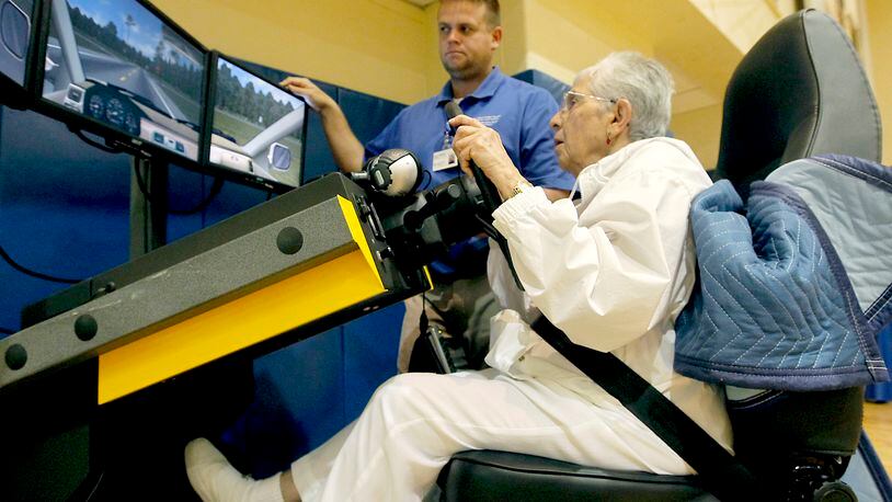 Frances Daubert of Centerville uses a driving simulator with assistance from Kyle Herman from the injury prevention center of Premier Health at Miami Valley Hospital. AAA held a Senior Driver Expo at Fairhaven Church in Centerville. Several interactive programs and activities were available to help drivers assess their driving skills. Seniors represent the fastest-growing segment of drivers. LISA POWELL / STAFF
