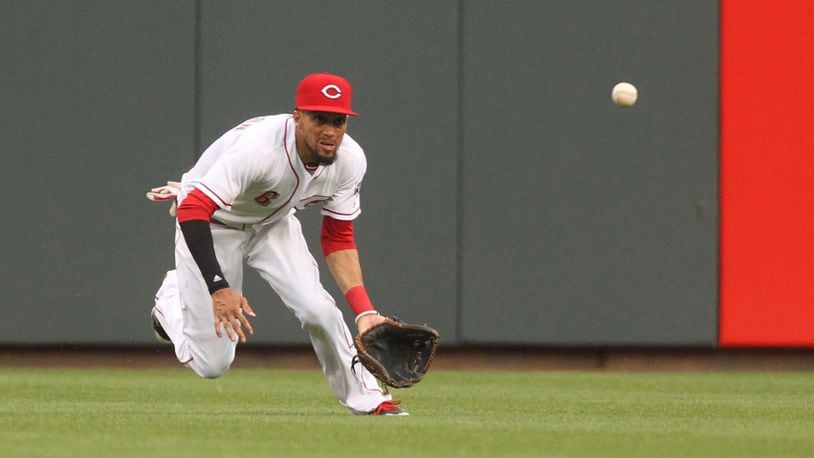 Reds center fielder Billy Hamilton dives but can’t catch a line drive against the Brewers on Friday, April 14, 2017, at Great American Ball Park in Cincinnati. David Jablonski/Staff