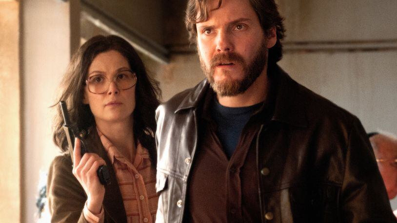 Rosamund Pike (left) stars as “Brigitte Kuhlman” and Daniel Brühl (right) stars as “Wilfred Bose” in José Padilha’s “7 Days in Entebbe.” Contributed by Liam Daniel / Focus Features