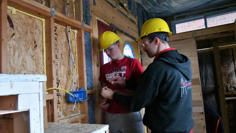 Tippecanoe High School student Noah McElhose works with teacher Jim Kitchen as work on the inside of the first tiny house, a project by the school homebuilding classes, continues to take shape. Work has begun on a second tiny house. CONTRIBUTED