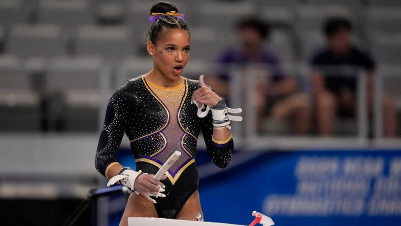 LSU's Haleigh Bryant gestures to teammates standing nearby as she prepares to compete on the uneven bars during the NCAA women's gymnastics championships in Fort Worth, Texas, Thursday, April 18, 2024. (AP Photo/Tony Gutierrez)