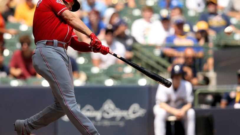 MILWAUKEE, WISCONSIN - JULY 24:  Josh VanMeter #17 of the Cincinnati Reds hits a home run in the third inning against the Milwaukee Brewers at Miller Park on July 24, 2019 in Milwaukee, Wisconsin. (Photo by Dylan Buell/Getty Images)