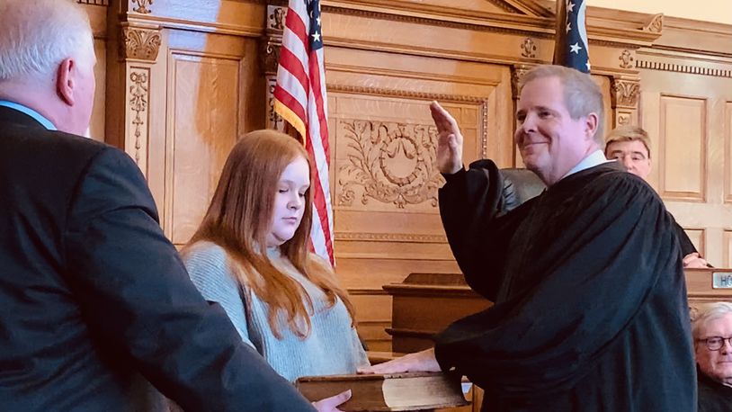 David McNamee is sworn in as Xenia Municipal Court Judge by his brother Michael  McNamee, with the Bible held by his daughter Sarah McNamee. LONDON BISHOP/STAFF