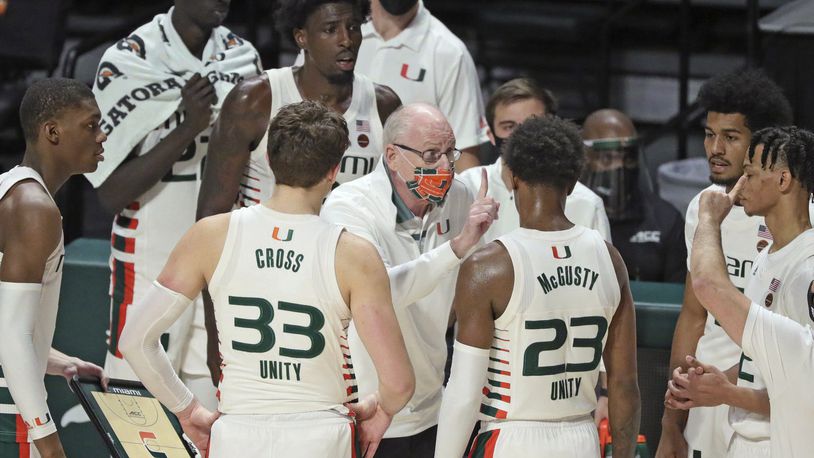 Miami coach Jim Larranaga talks to players during the second half of the team's NCAA college basketball game against Purdue on Tuesday, Dec. 8, 2020, in Coral Gables, Fla. (Al Diaz/Miami Herald via AP)